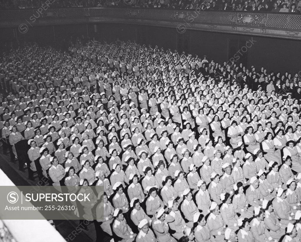 Stock Photo: 255-26310 High angle view of a group of Red Cross volunteers sitting in an auditorium
