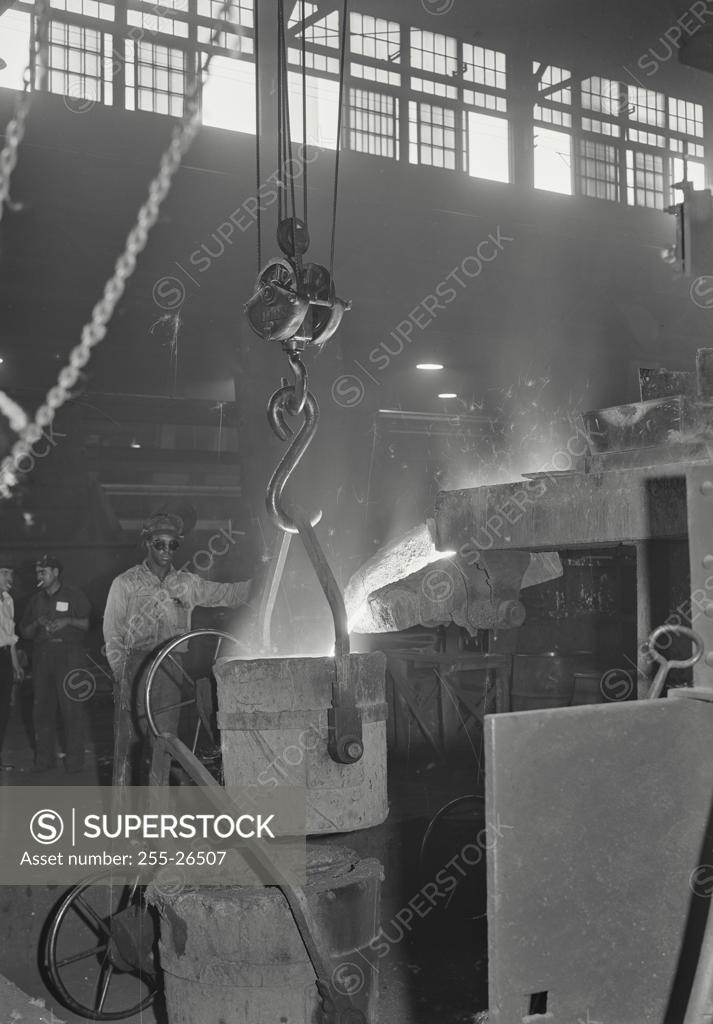 Stock Photo: 255-26507 Two foundry workers working in an iron foundry