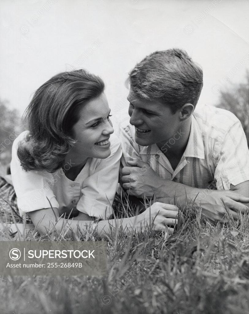 Stock Photo: 255-26849B Close-up view of young couple lying in park