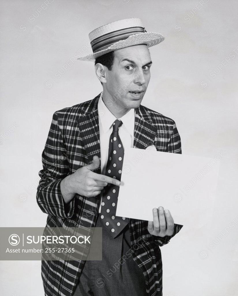Stock Photo: 255-27365 Close-up of a mature man pointing at a blank placard