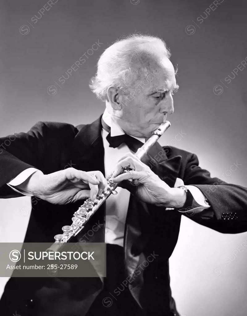 Senior man playing a flute