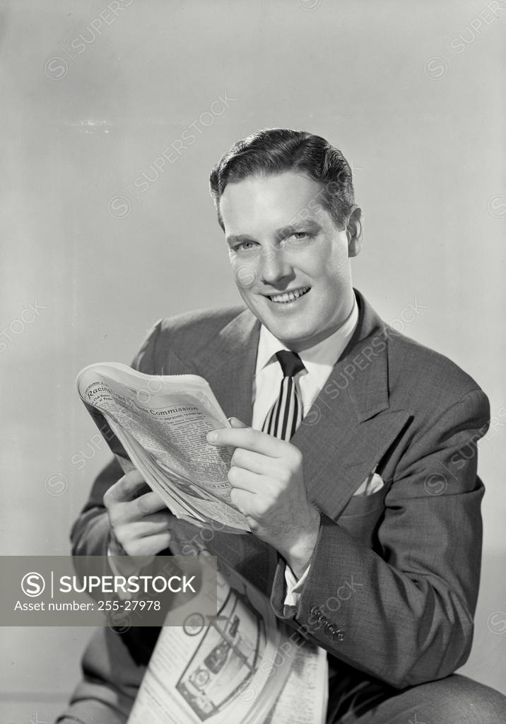 Stock Photo: 255-27978 Portrait of a businessman holding a newspaper