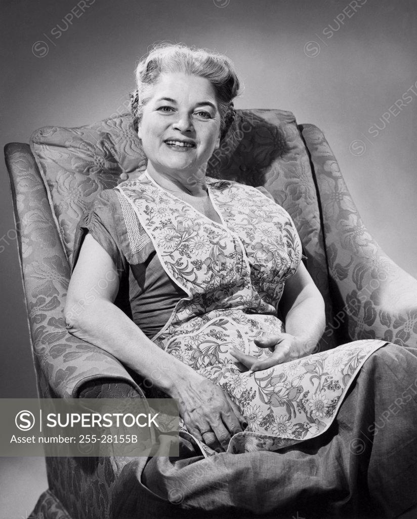 Stock Photo: 255-28155B Portrait of a senior woman sitting on an armchair