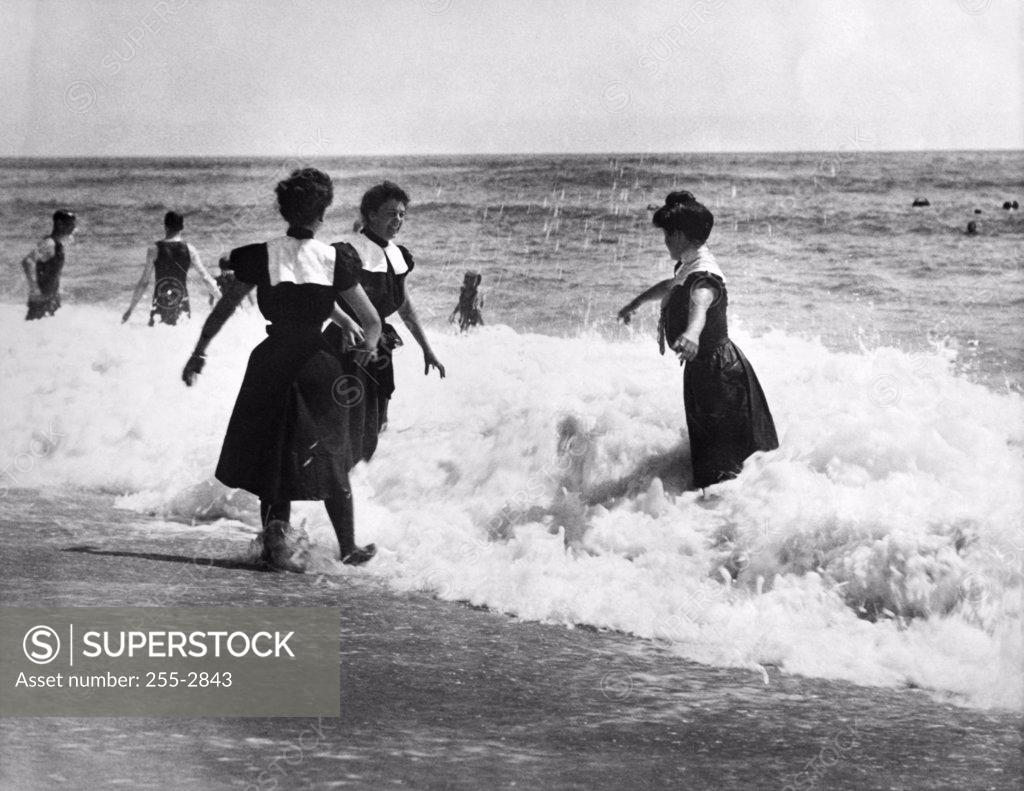 Stock Photo: 255-2843 Three young women playing on the beach