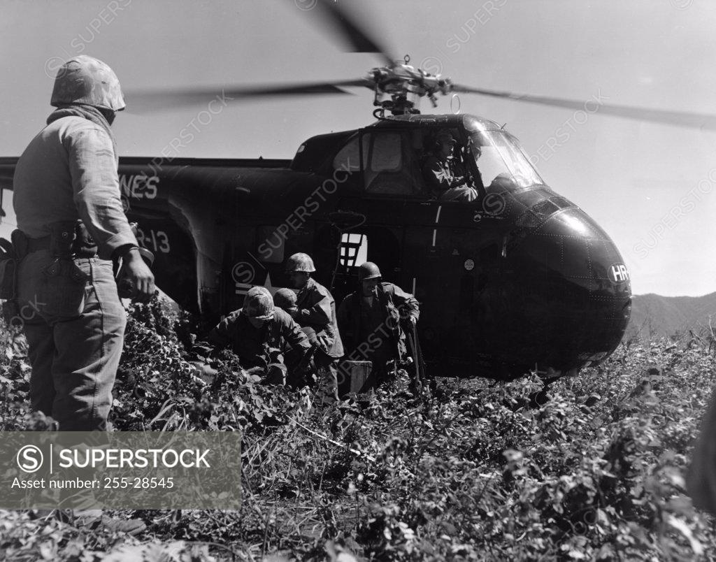 Stock Photo: 255-28545 Korea, US Marine Corps, soldiers exiting military helicopter