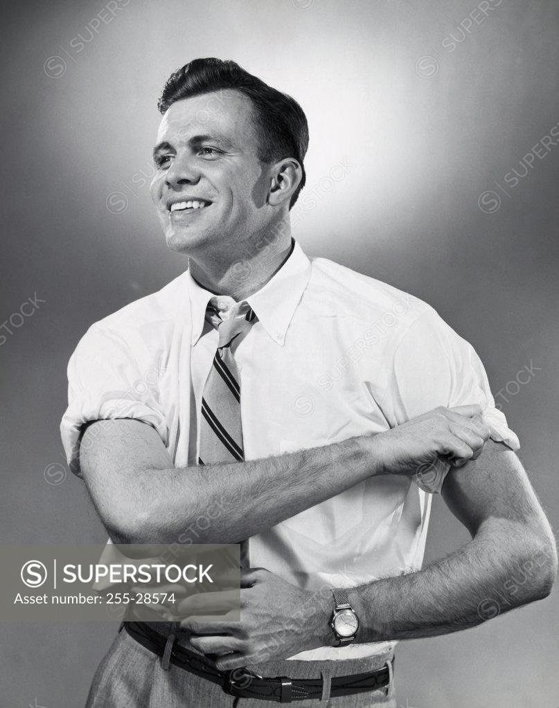 Stock Photo: 255-28574 Close-up of a businessman rolling up his sleeves