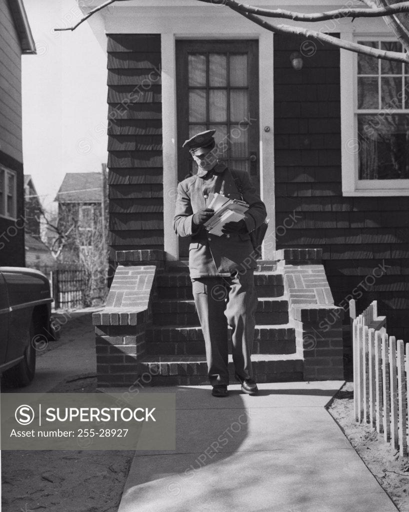 Stock Photo: 255-28927 Postman delivering mail