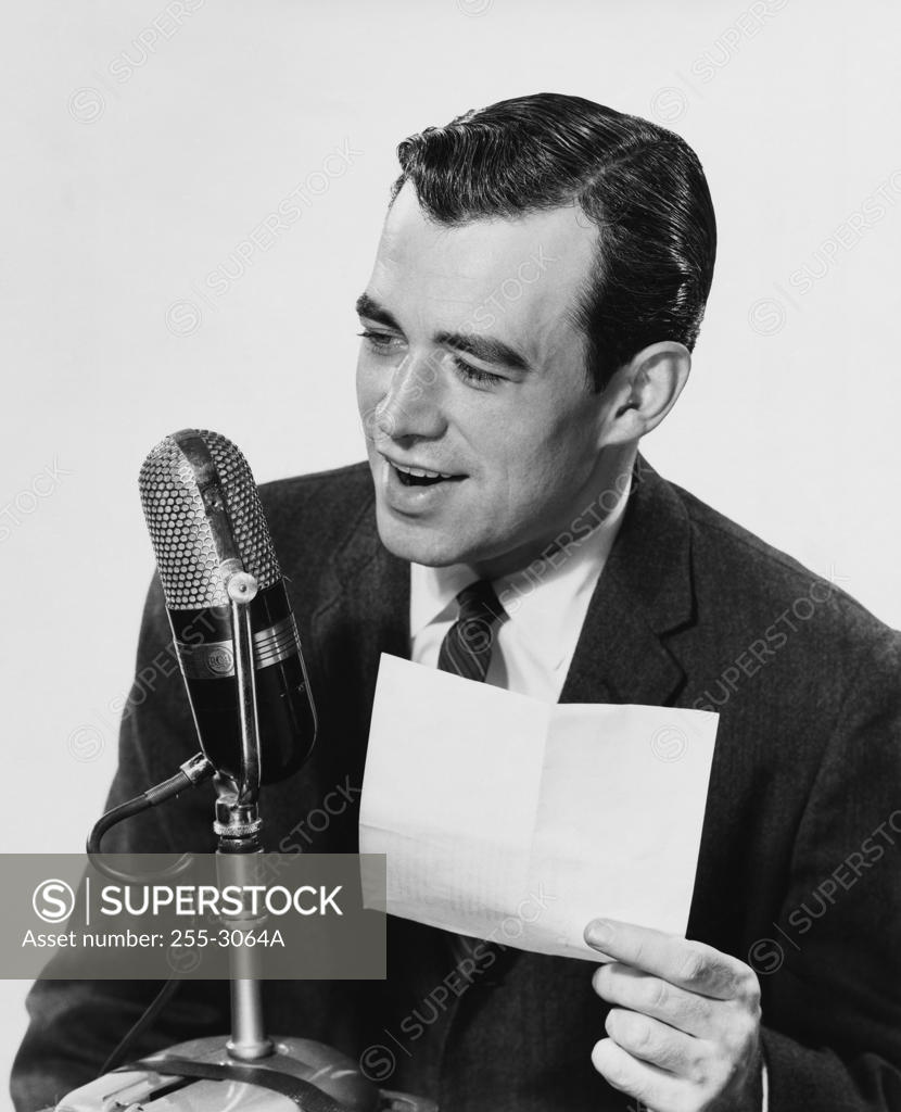 Stock Photo: 255-3064A Mid adult man speaking into a microphone