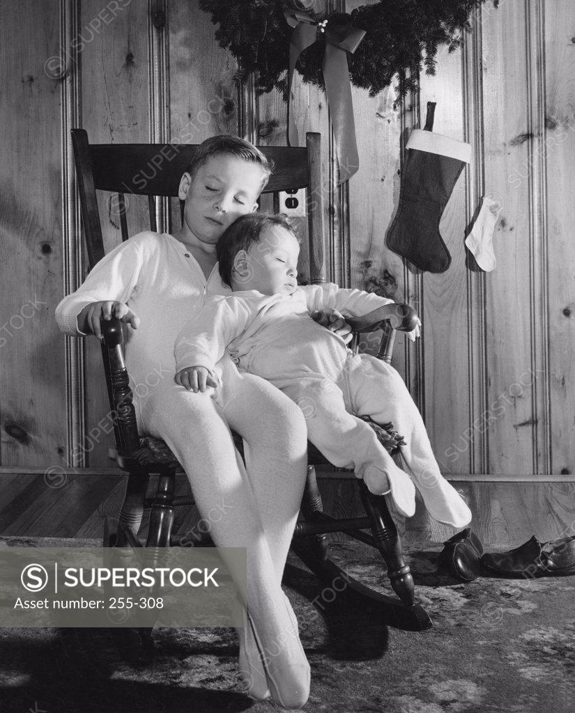 Stock Photo: 255-308 Two boys sleeping in a rocking chair
