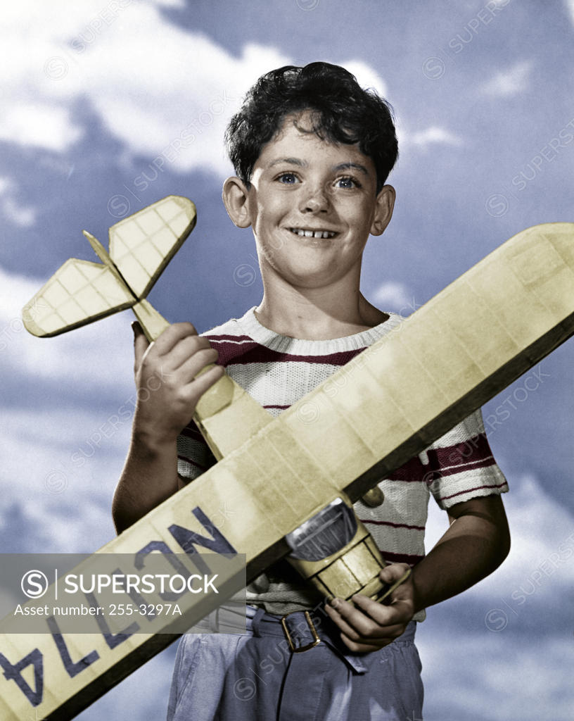 Stock Photo: 255-3297A Boy holding model airplane