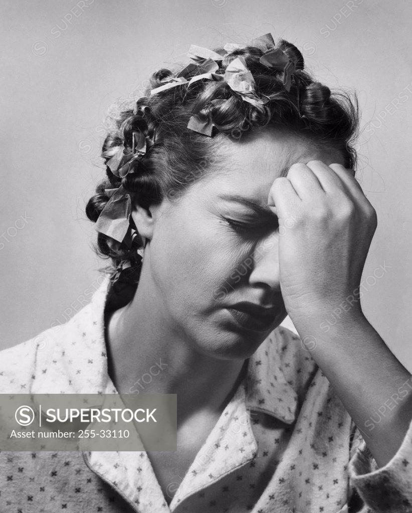 Stock Photo: 255-33110 Close-up of a mid adult woman suffering from a headache