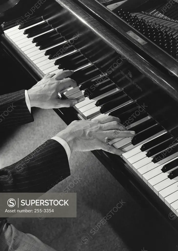 High angle view of a person's hands playing the piano