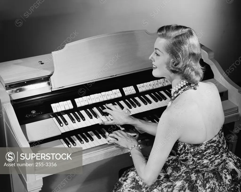 High angle view of a young woman playing an organ