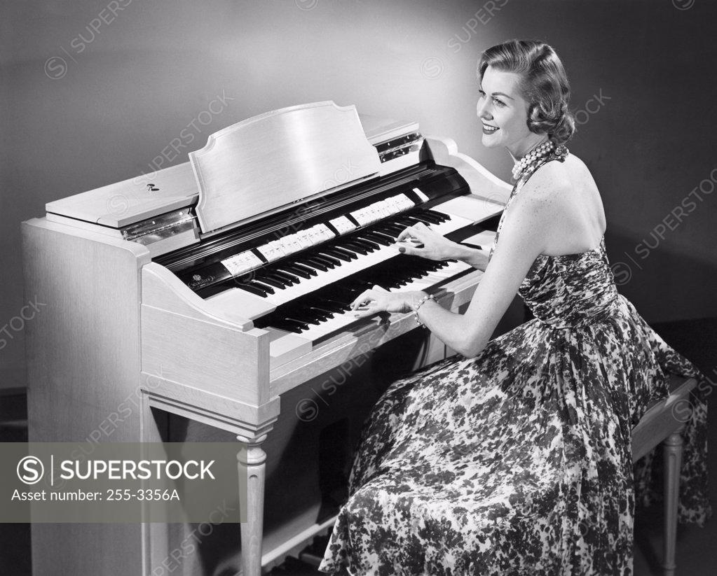 Stock Photo: 255-3356A Side profile of a young woman playing an organ