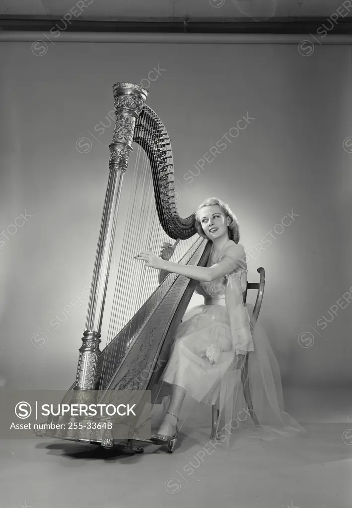 Young woman playing a harp