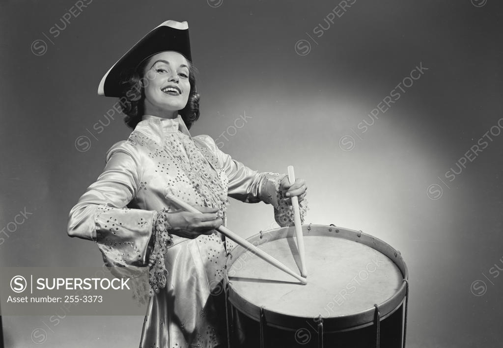 Stock Photo: 255-3373 Portrait of a young woman playing the drum