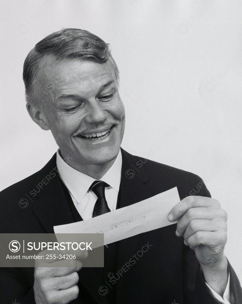 Stock Photo: 255-34206 Close-up of a businessman looking at a check