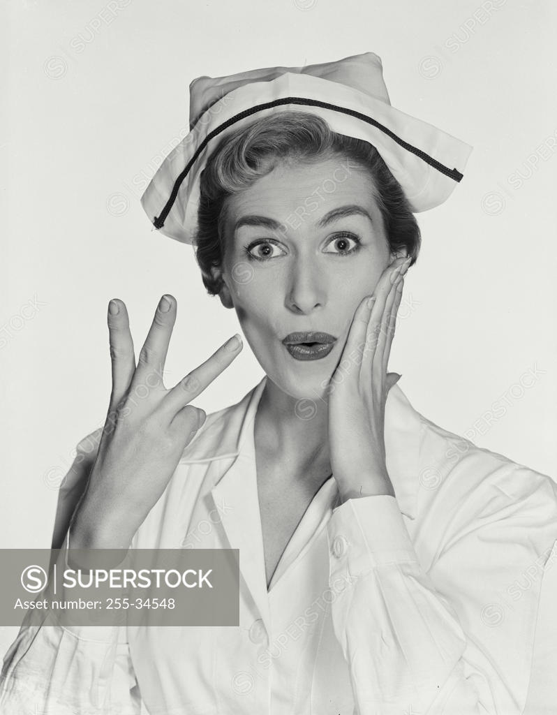 Stock Photo: 255-34548 Portrait of a female nurse gesturing and looking surprised
