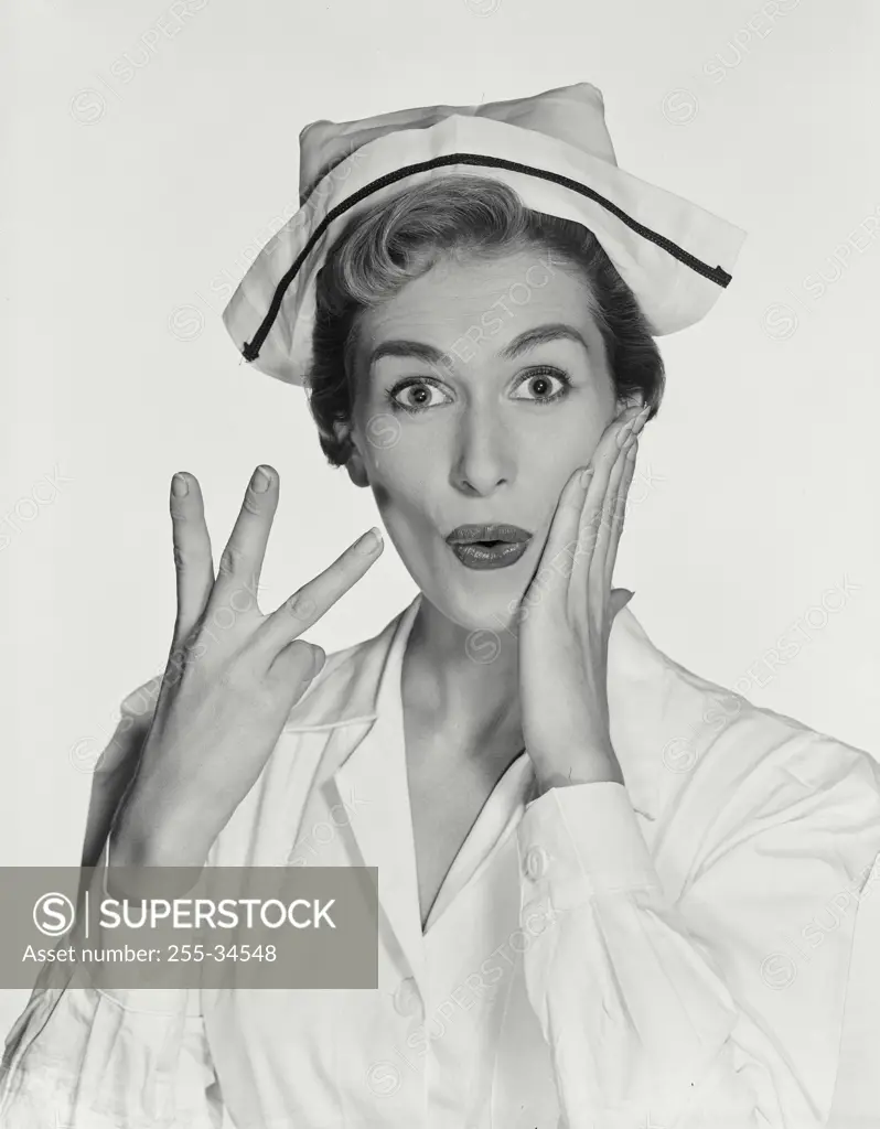 Portrait of a female nurse gesturing and looking surprised