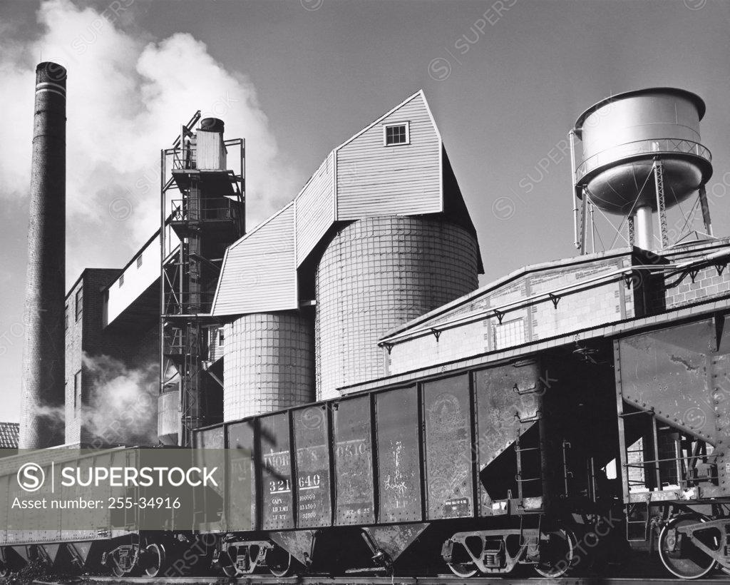 Stock Photo: 255-34916 Freight train in front of a coal silo of a paper mill