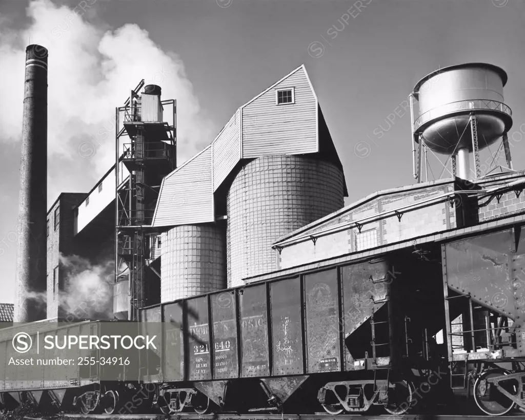 Freight train in front of a coal silo of a paper mill