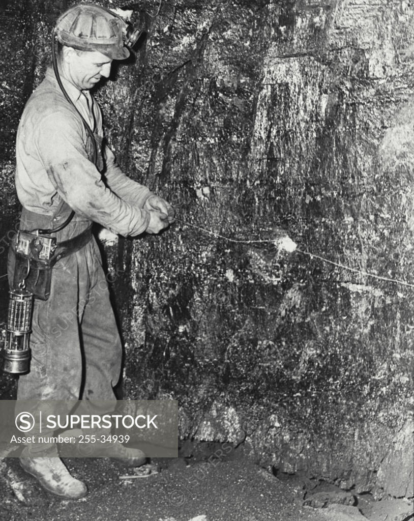 Stock Photo: 255-34939 Side profile of a coal miner working in a pit mine