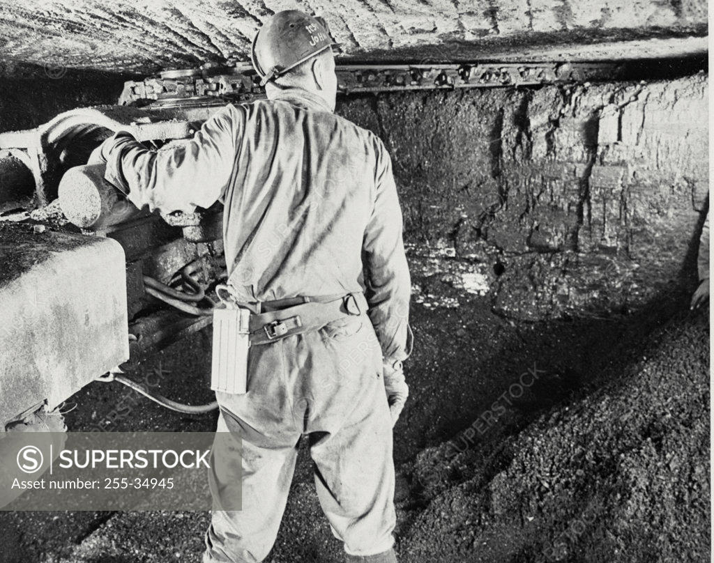 Stock Photo: 255-34945 Rear view of a miner working in a coal mine, Pennsylvania, USA