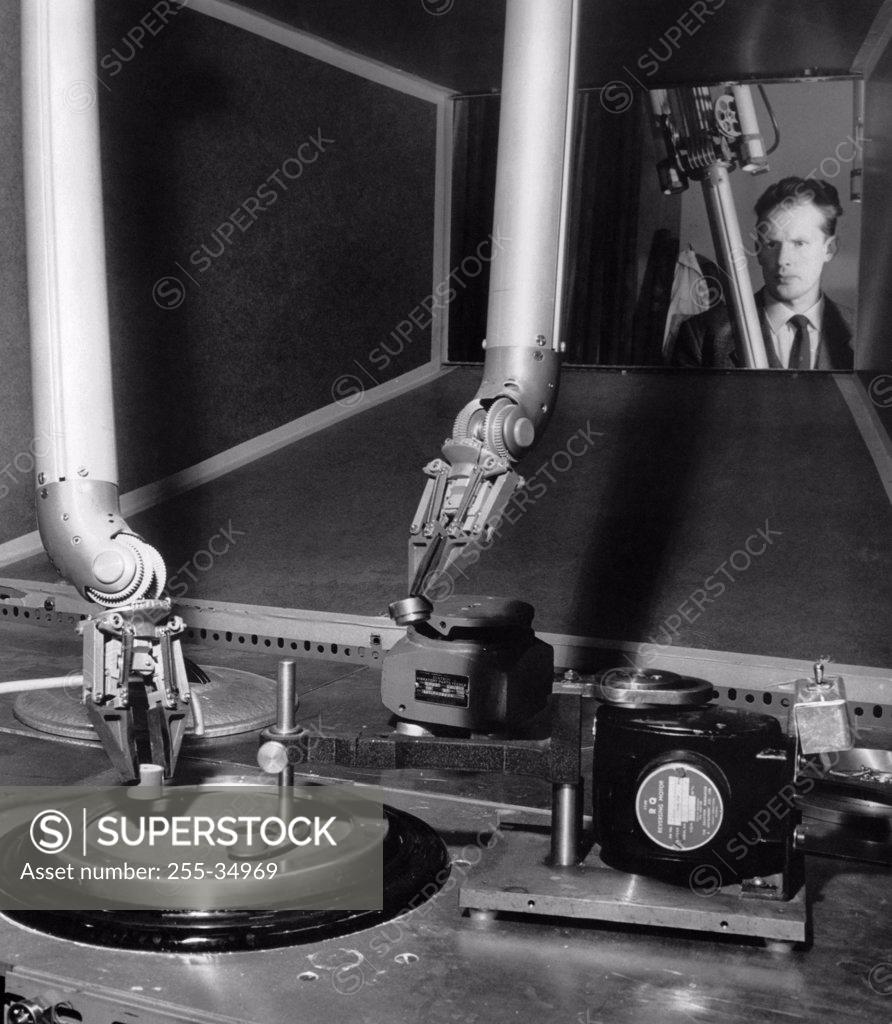 Stock Photo: 255-34969 Scientist looking at a machine in a nuclear laboratory