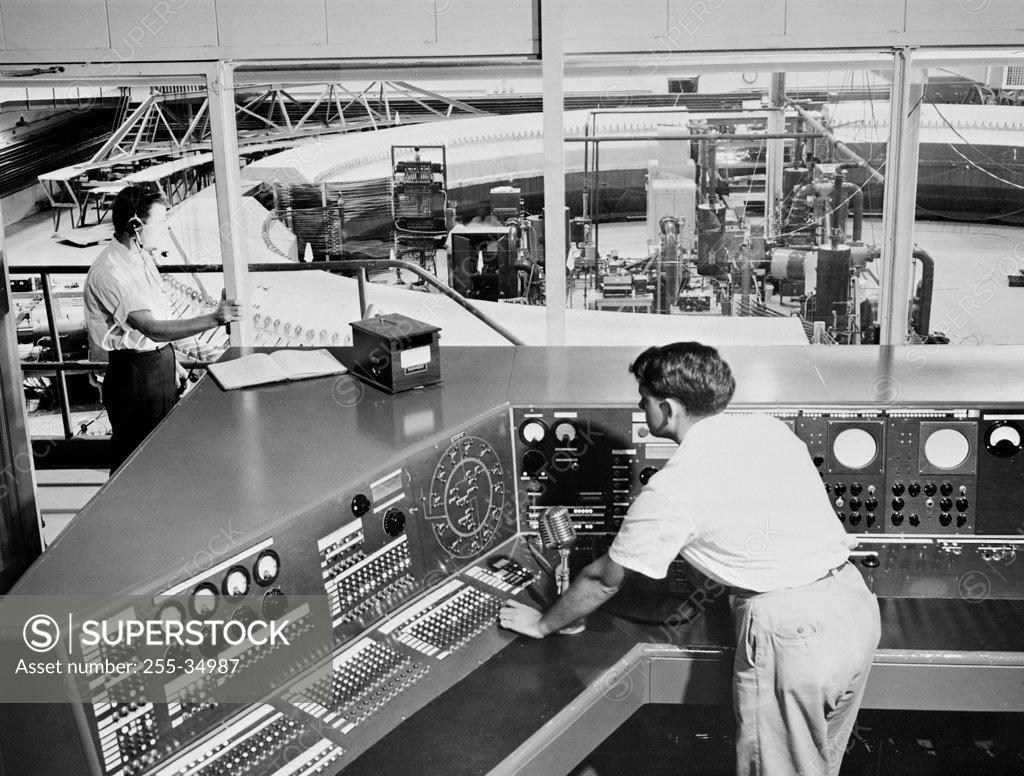 Stock Photo: 255-34987 High angle view of scientists working in a control room of a laboratory, Brookhaven National Laboratory, Upton, Long Island, New York State, USA
