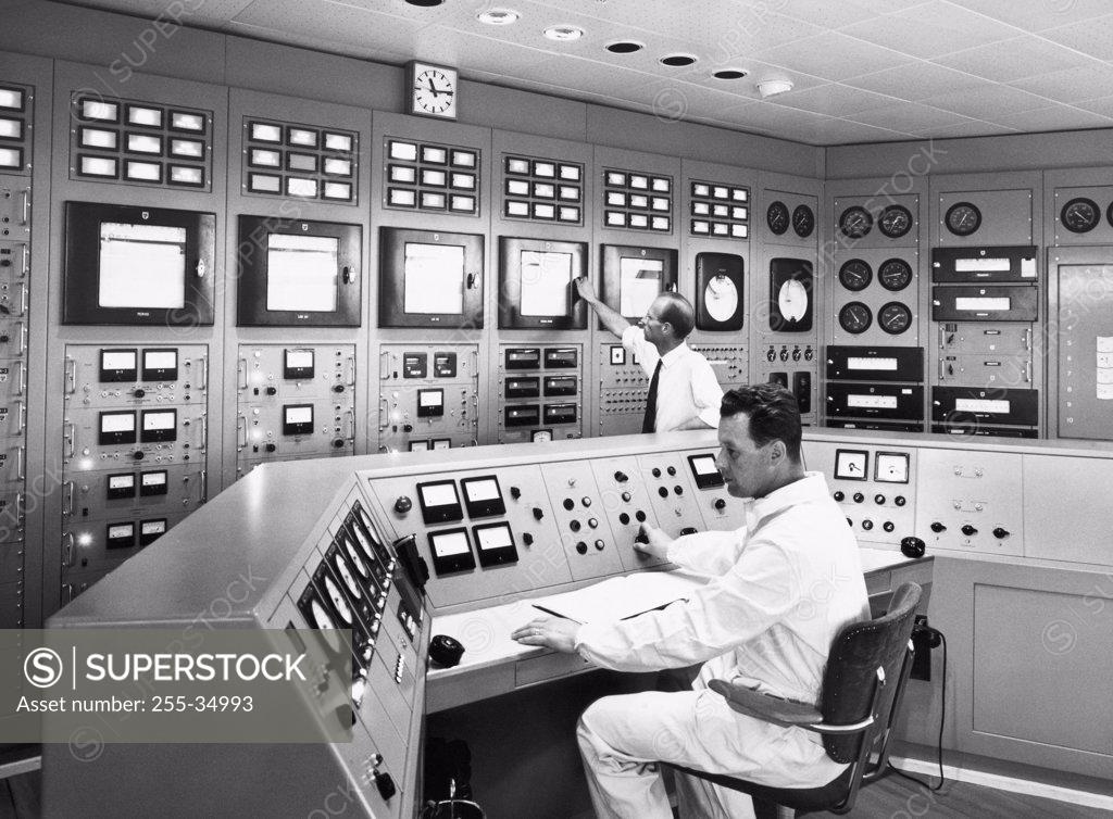 Stock Photo: 255-34993 Scientists working in a control room of a laboratory, Stockholm, Sweden