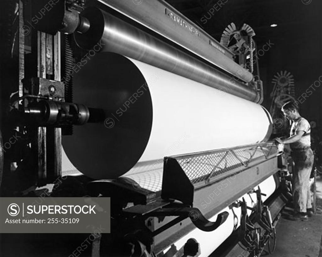 Stock Photo: 255-35109 Side profile of a worker working in a paper mill
