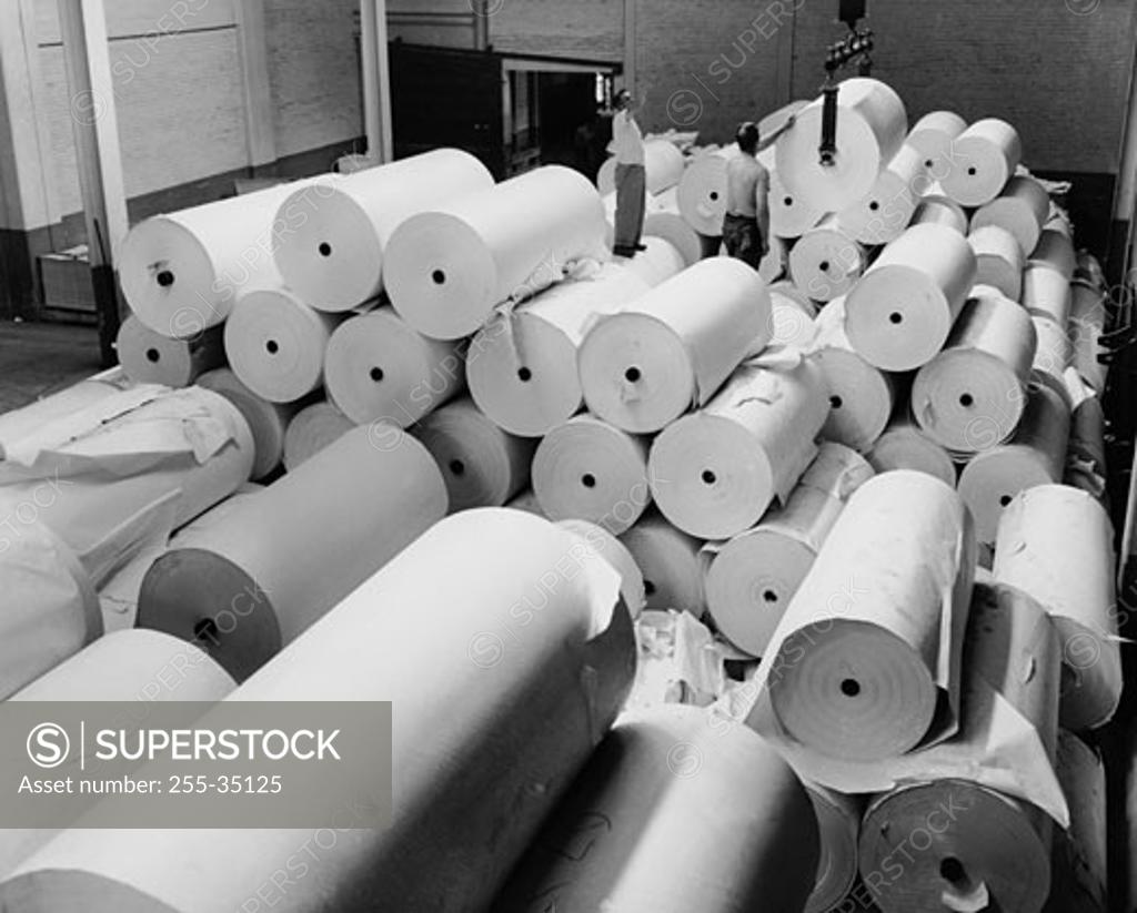 Stock Photo: 255-35125 High angle view of two men working in a paper warehouse