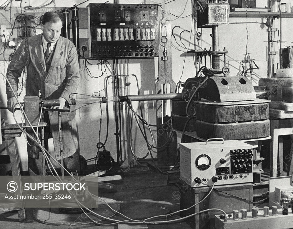 Stock Photo: 255-35246 Scientist experimenting on artificial transmutation in a high voltage laboratory, Cavendish Laboratory, University Of Cambridge, England