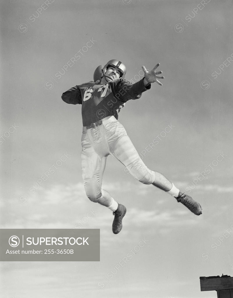 Stock Photo: 255-3650B Low angle view of a football player throwing a football