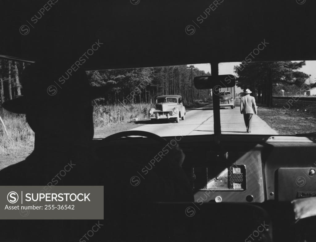 Stock Photo: 255-36542 Silhouette of a man driving a car