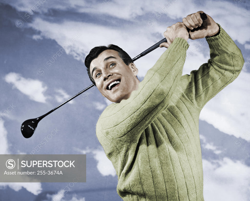 Stock Photo: 255-3674A Close-up of mid adult man swinging golf club