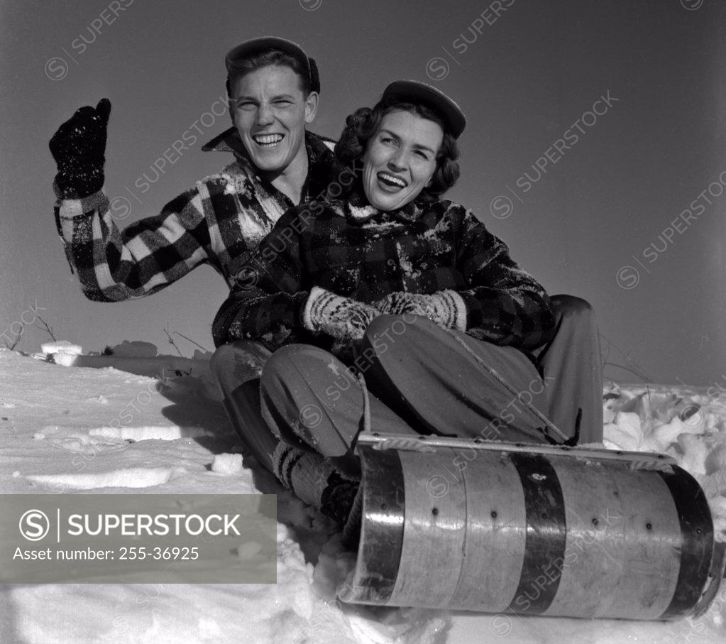 Stock Photo: 255-36925 Young couple sleighing
