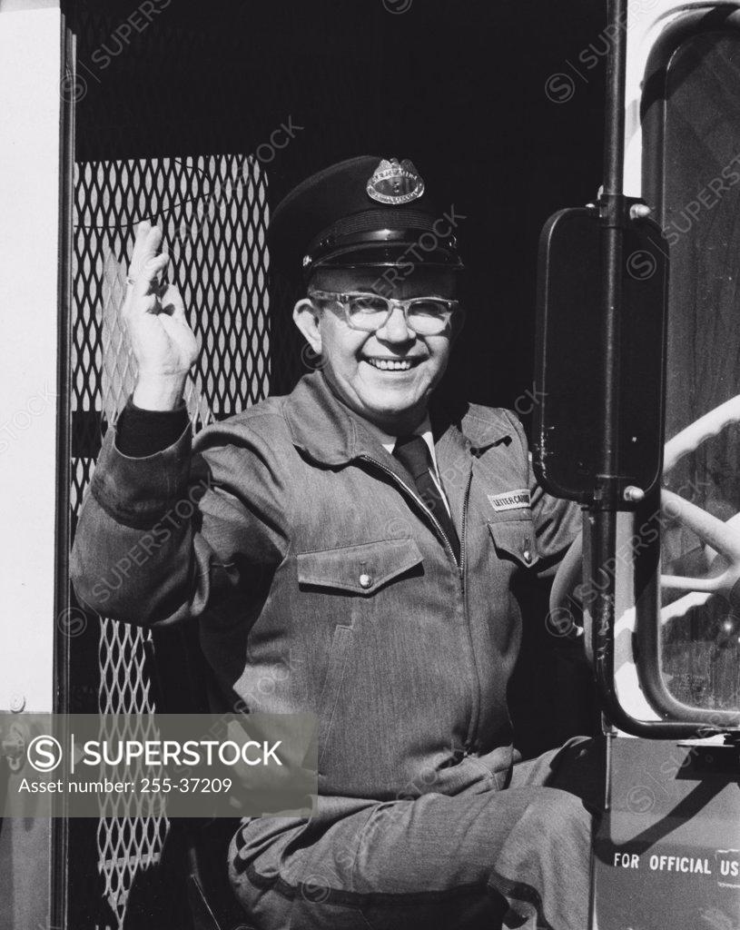 Stock Photo: 255-37209 Portrait of a truck driver waving his hand