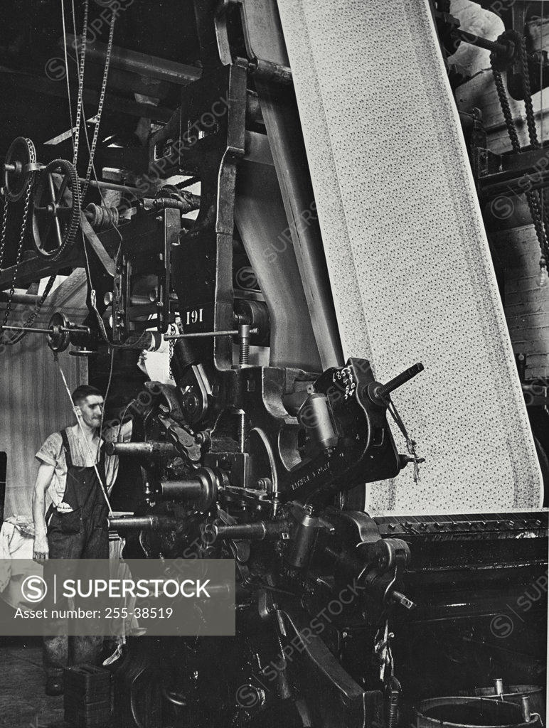 Stock Photo: 255-38519 Worker working on a cotton printing machine in a cotton mill, England