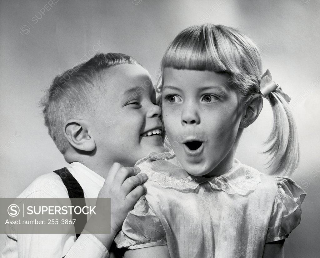 Stock Photo: 255-3867 Boy whispering to a girl