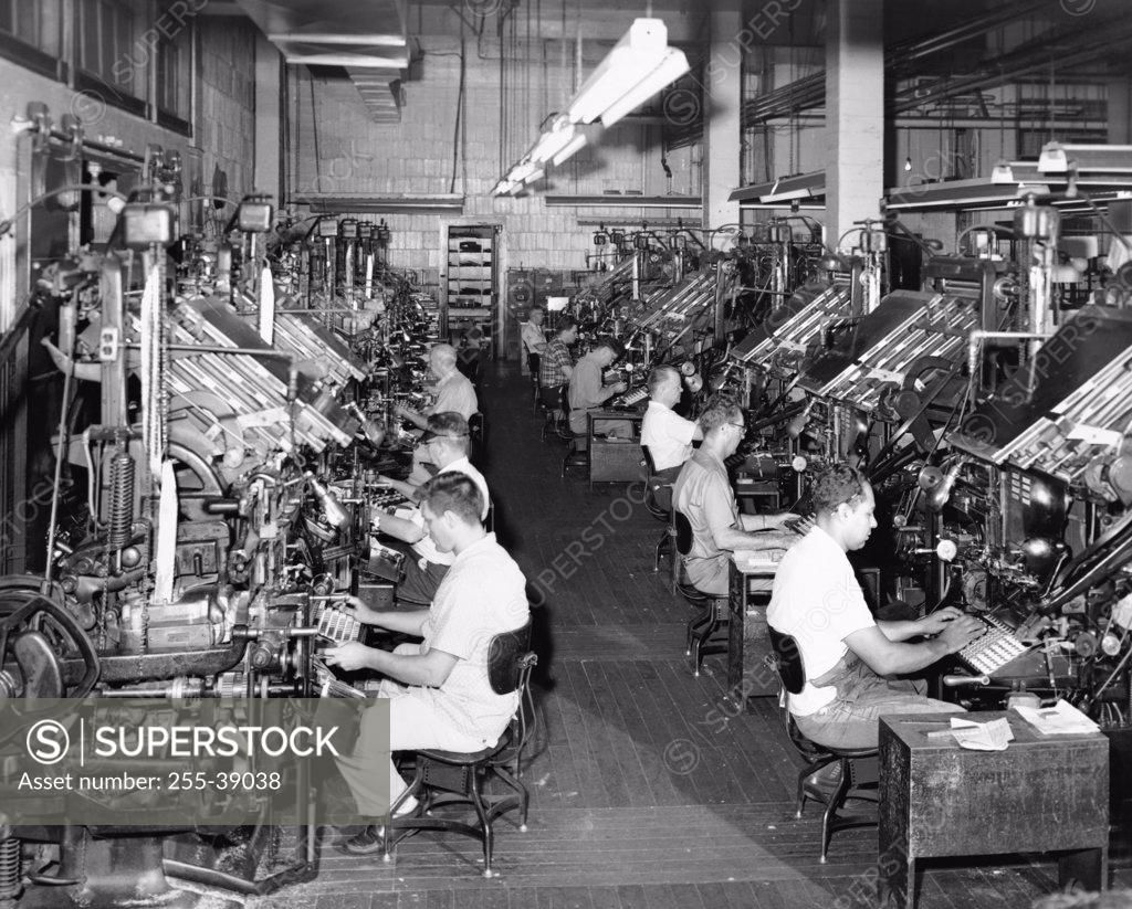 Stock Photo: 255-39038 Group of male workers operating linotype machines in a newspaper printing press, New Orleans Times-Picayune, New Orleans, Louisiana, USA