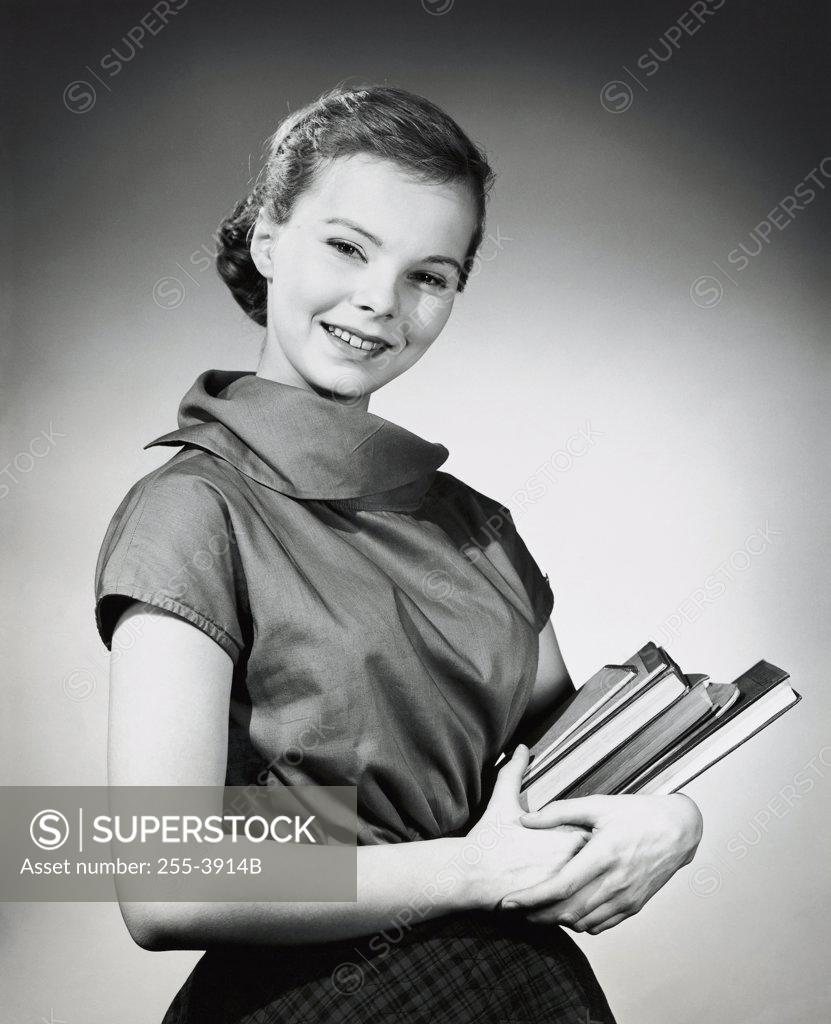 Stock Photo: 255-3914B Teenage girl carrying books