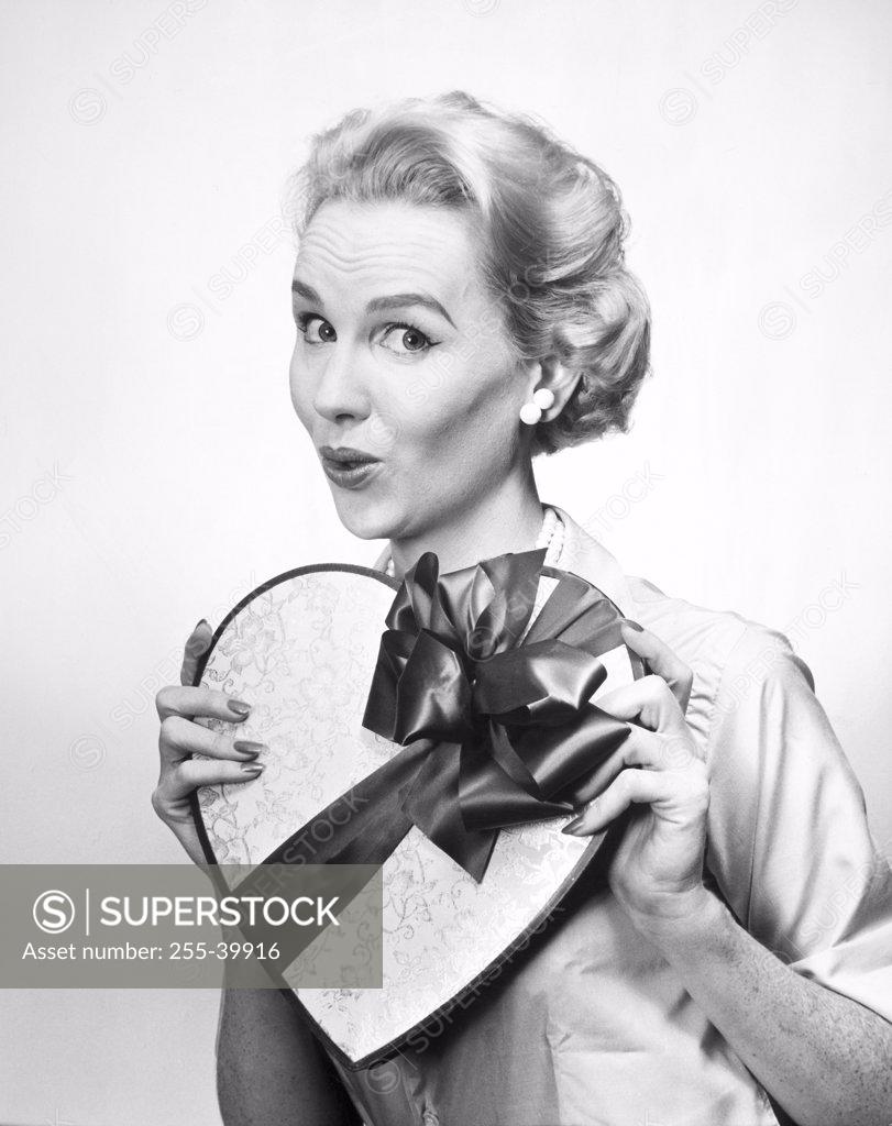 Stock Photo: 255-39916 Portrait of mid adult woman holding Valentine gift