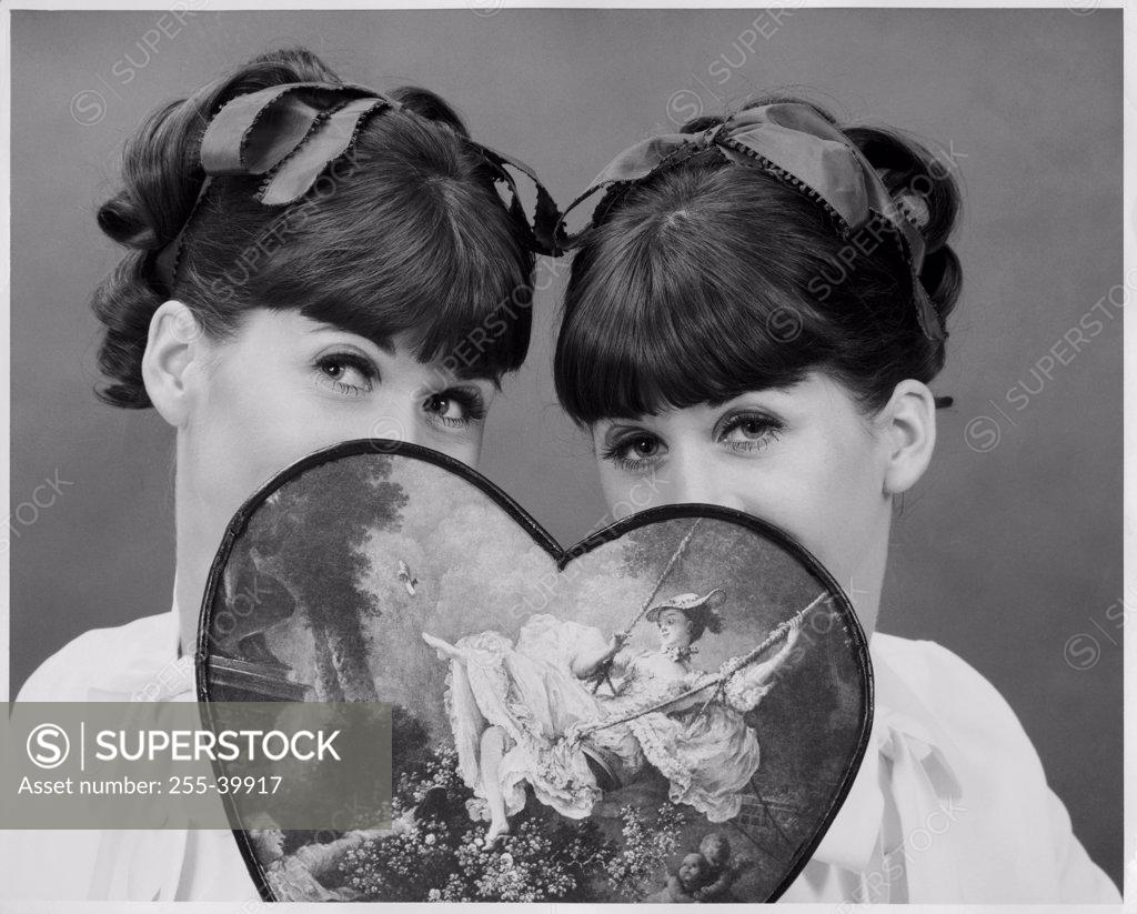 Stock Photo: 255-39917 Portrait of two girls holding a Valentine gift