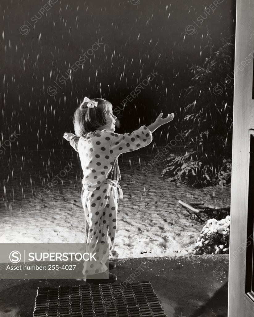 Stock Photo: 255-4027 Side profile of a girl watching snow falling