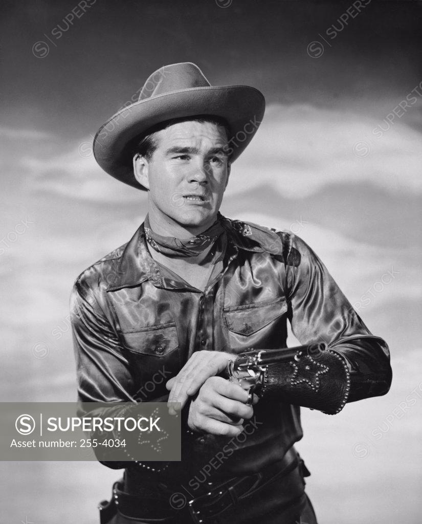 Stock Photo: 255-4034 Close-up of a cowboy holding a pistol