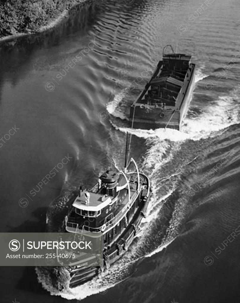 Stock Photo: 255-40675 High angle view of a tugboat pulling a cargo container