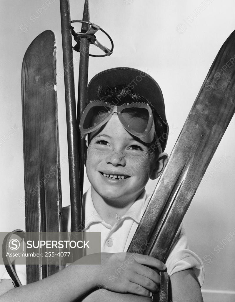 Stock Photo: 255-4077 Boy holding skiing equipment