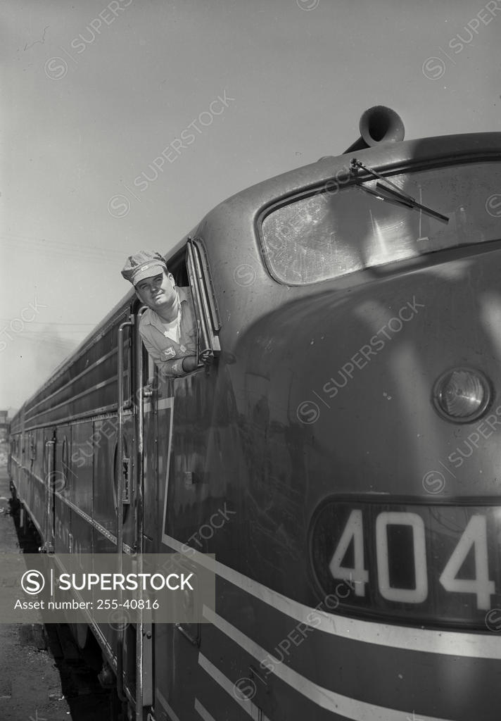 Stock Photo: 255-40816 Driver looking out through the window of a passenger train
