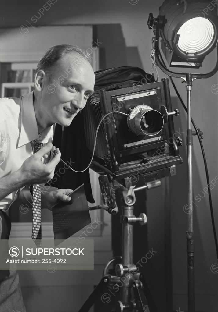 Stock Photo: 255-4092 Photographer operating a camera in a studio